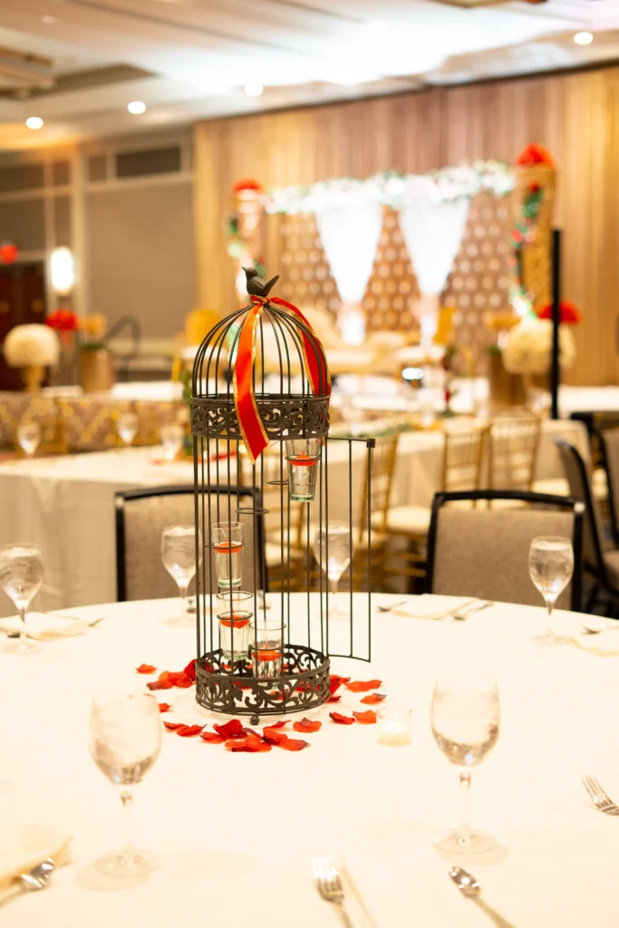 birdcage candle centerpiece red petals banquet table