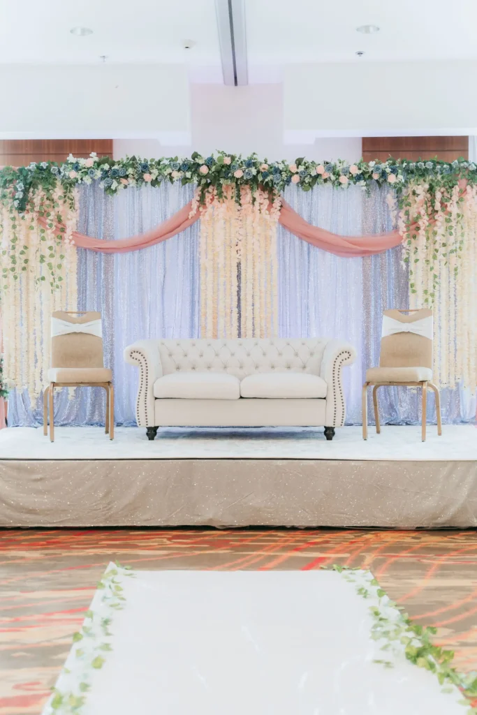 blush blue sequin stage wisteria backdrop tufted sofa
