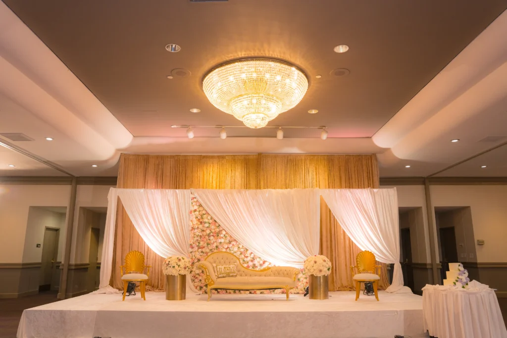 gold sofa floral wall stage wide chandelier view