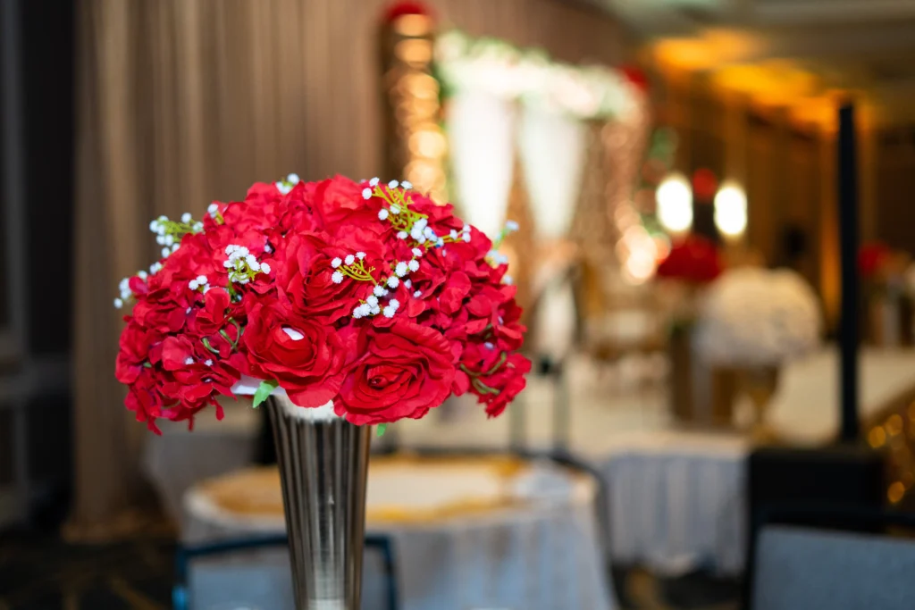 red rose bouquet silver vase wedding reception