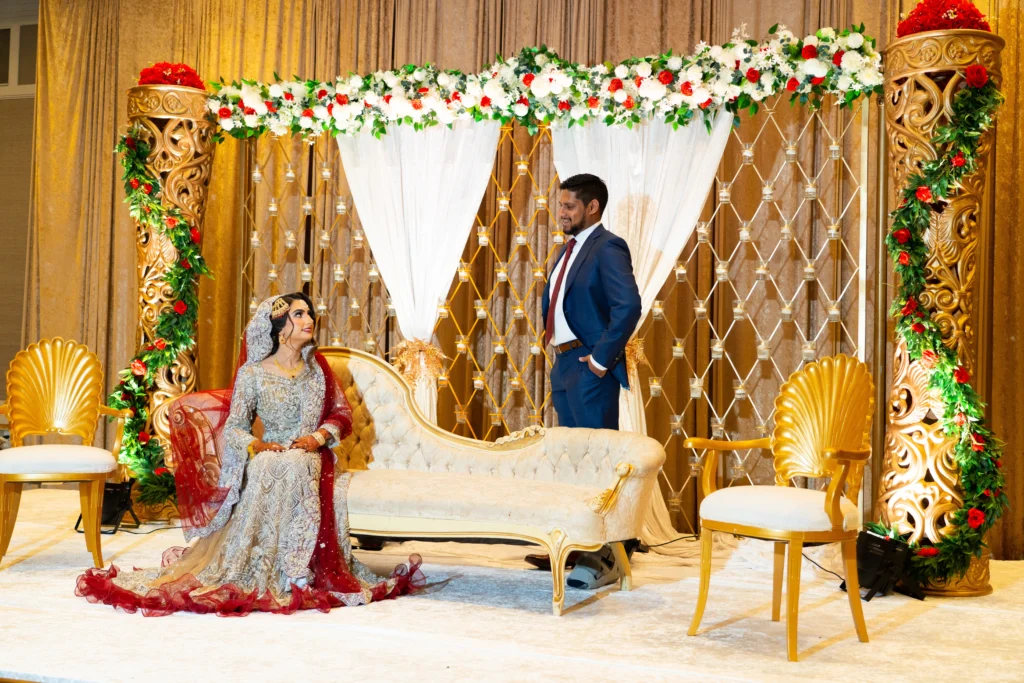south asian bride gold sofa ornate stage red flowers