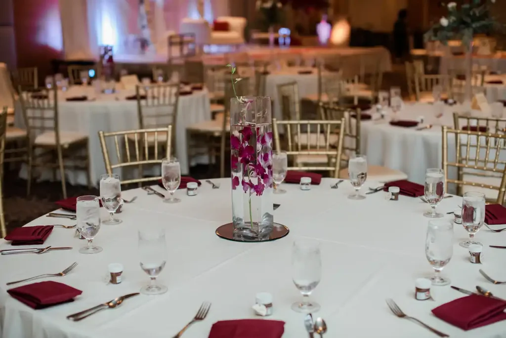 submerged orchid glass vase burgundy napkin reception table