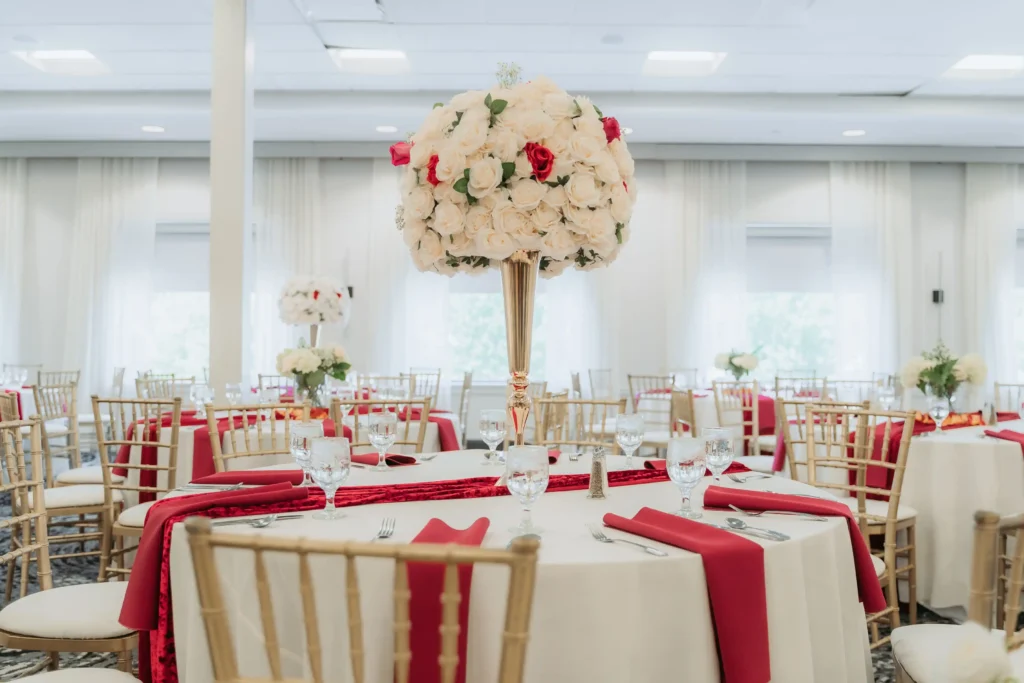 tall ivory rose centerpiece red runner reception hall