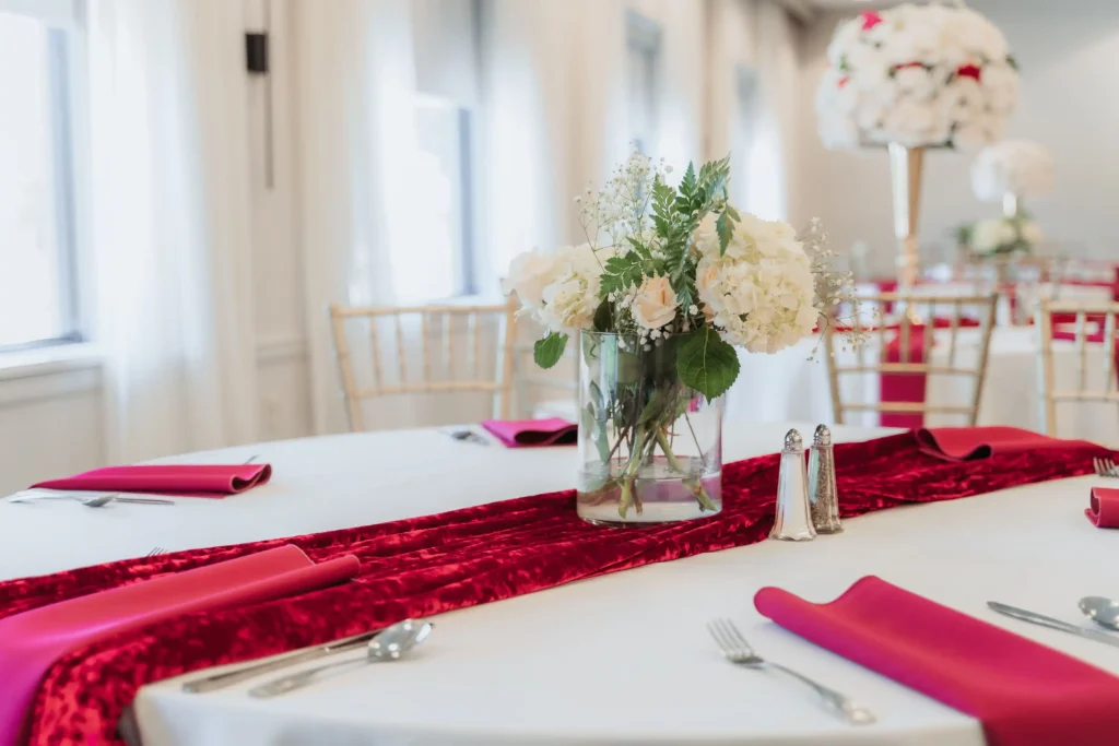 wedding table crimson runner white hydrangea centerpiece