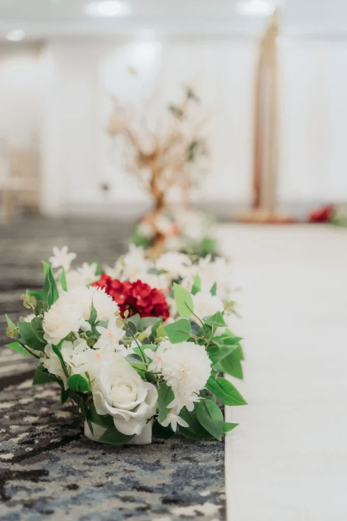 white floral aisle arrangement ceremony carpet