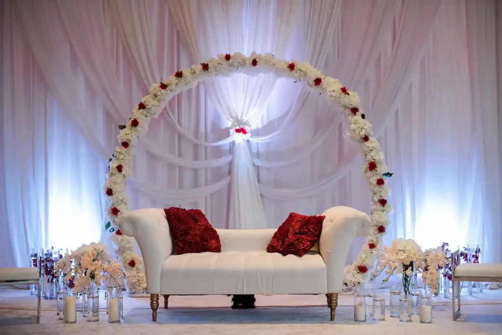white floral circular arch empty sofa red pillows