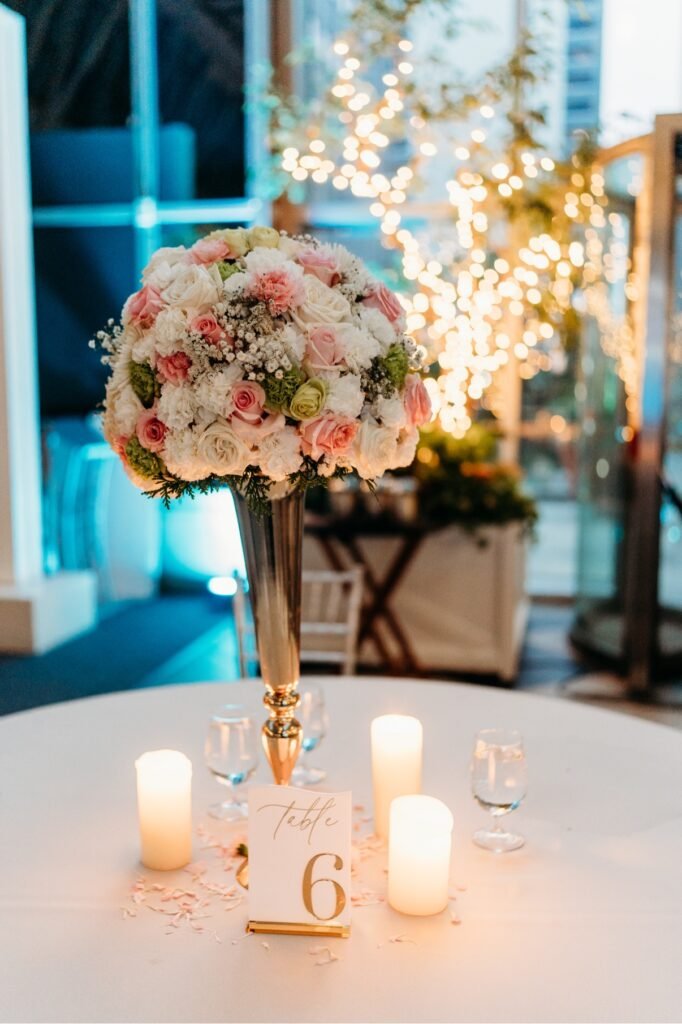 Burgundy wedding stage with white arches and red florals by Regal Event Decor