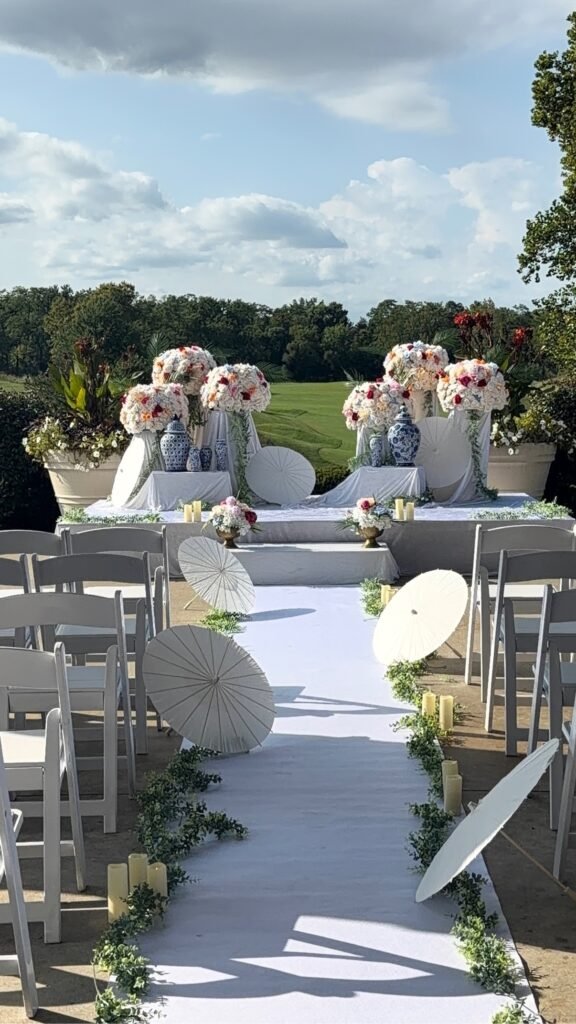Tall gold trumpet vase centerpiece with pink and white roses by Regal Event Decor