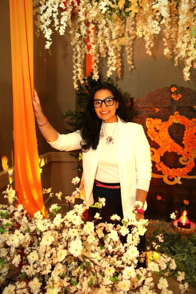 Aarzu Ahmed-Rehman, luxury wedding designer in Pittsburgh, styling a red drape installation