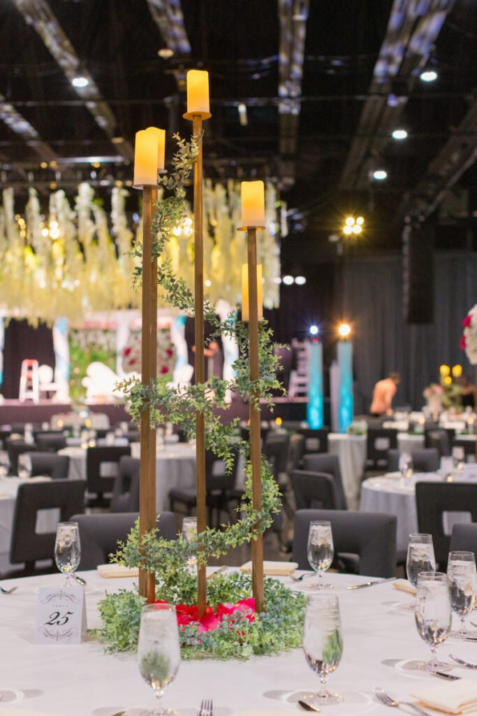 Candlestick wedding centerpiece Pittsburgh — tall candlesticks with greenery runner on reception table