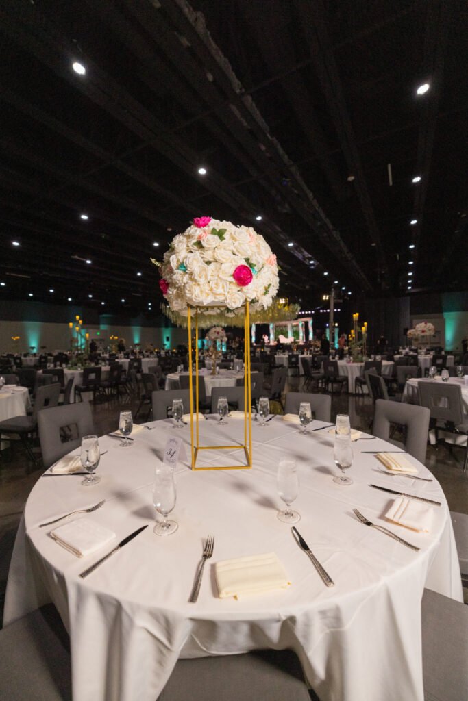 Tall floral centerpiece Pittsburgh — pink and white blooms on ornate gold stand at luxury wedding reception