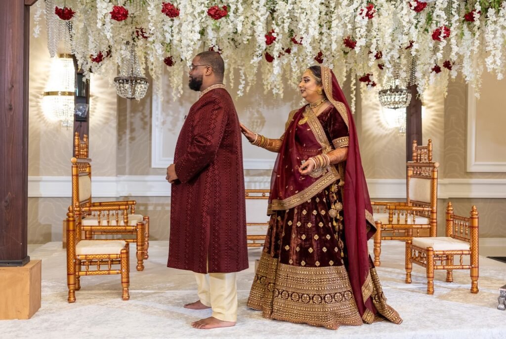 Fusion wedding ceremony at The Westin Mount Laurel by Regal Event Decor — bride and groom in maroon velvet on the mandap stage