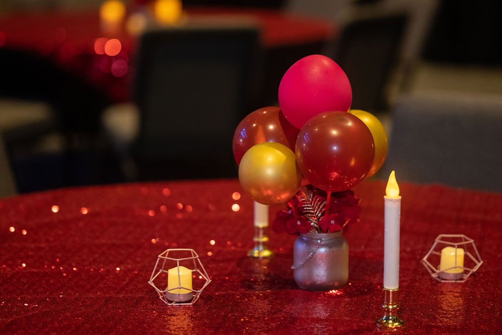 Ruby red birthday stage design Pittsburgh — dramatic red draped stage, luxury 40th birthday event decor